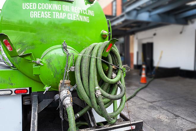 a grease trap pumping service in action at a commercial building in Alpharetta GA